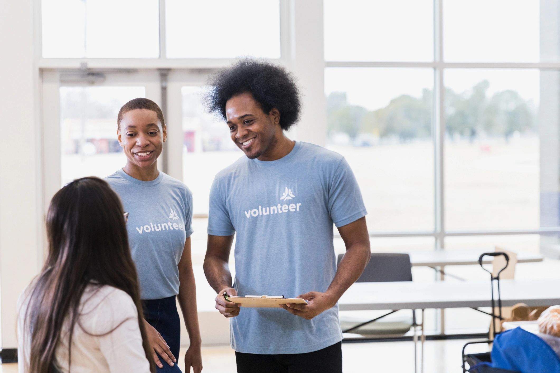Couple registering a young participant for a community event