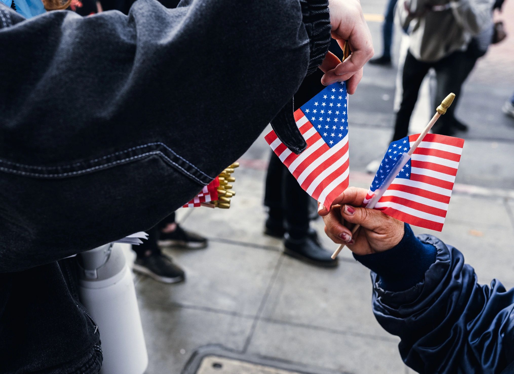 Small American flags held by participants at a civic gathering